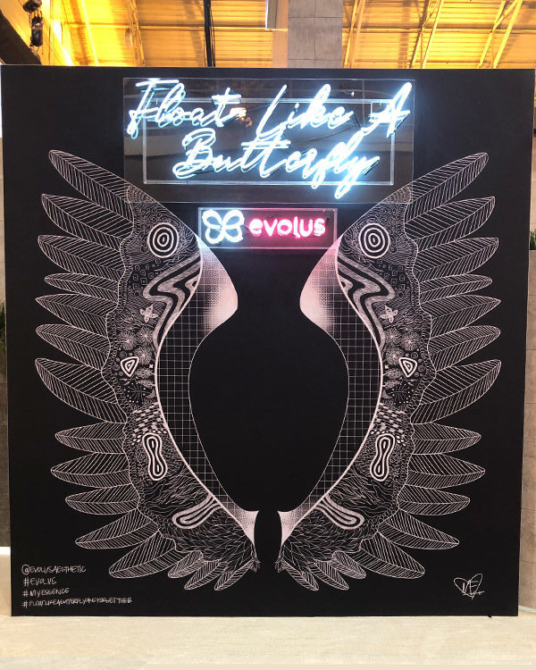 evolus-brand-activation-trade-show-booth-butterfly-wings-neon-lights-fgpg-experiential-600x750
