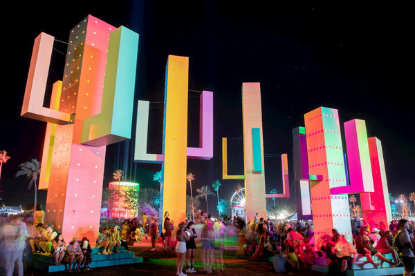 bright colored large cactus sculptures at coachella nighttime