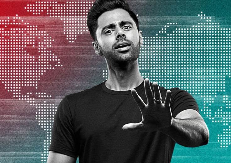 hasan minhaj posing in front of a red and blue map for a keynote