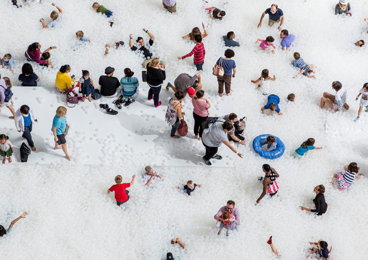people playing in a large playpen of white balls for Instagram Museums