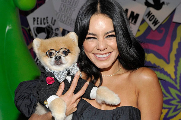 vanessa hudgens holding a dog in a suit and glasses at the museum of cannabis