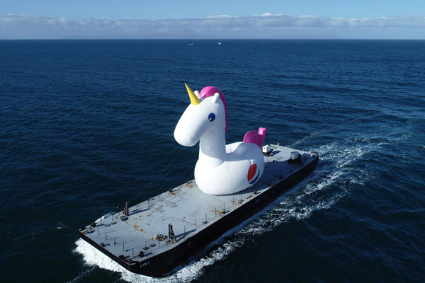 giant unicorn inflatable on a boat at sea for brand activations