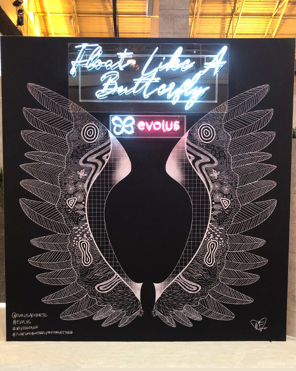 evolus brand activation trade show booth butterfly wings neon lights fgpg experiential