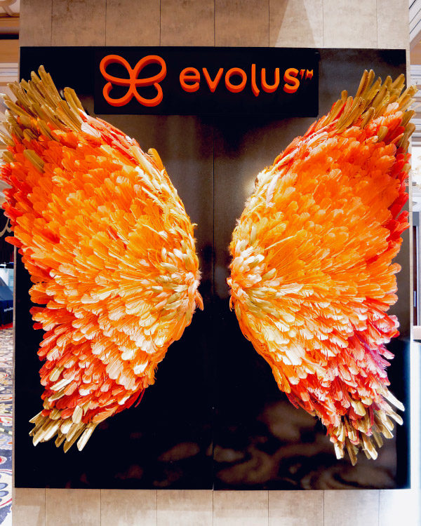 evolus brand activation trade show booth butterfly wings orange feathers fgpg experiential
