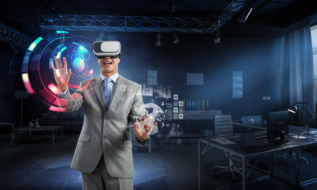 Businessman dressed in a suite enjoying a virtual reality set while making movements with his hands in an experiential marketing setting