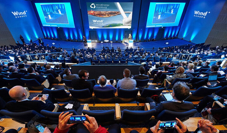 image of audience sitting and watching a stage for the blockchain fest 2022 event for cryptocurrency market 2022